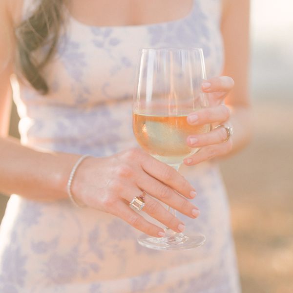 woman holding a glass of white wine