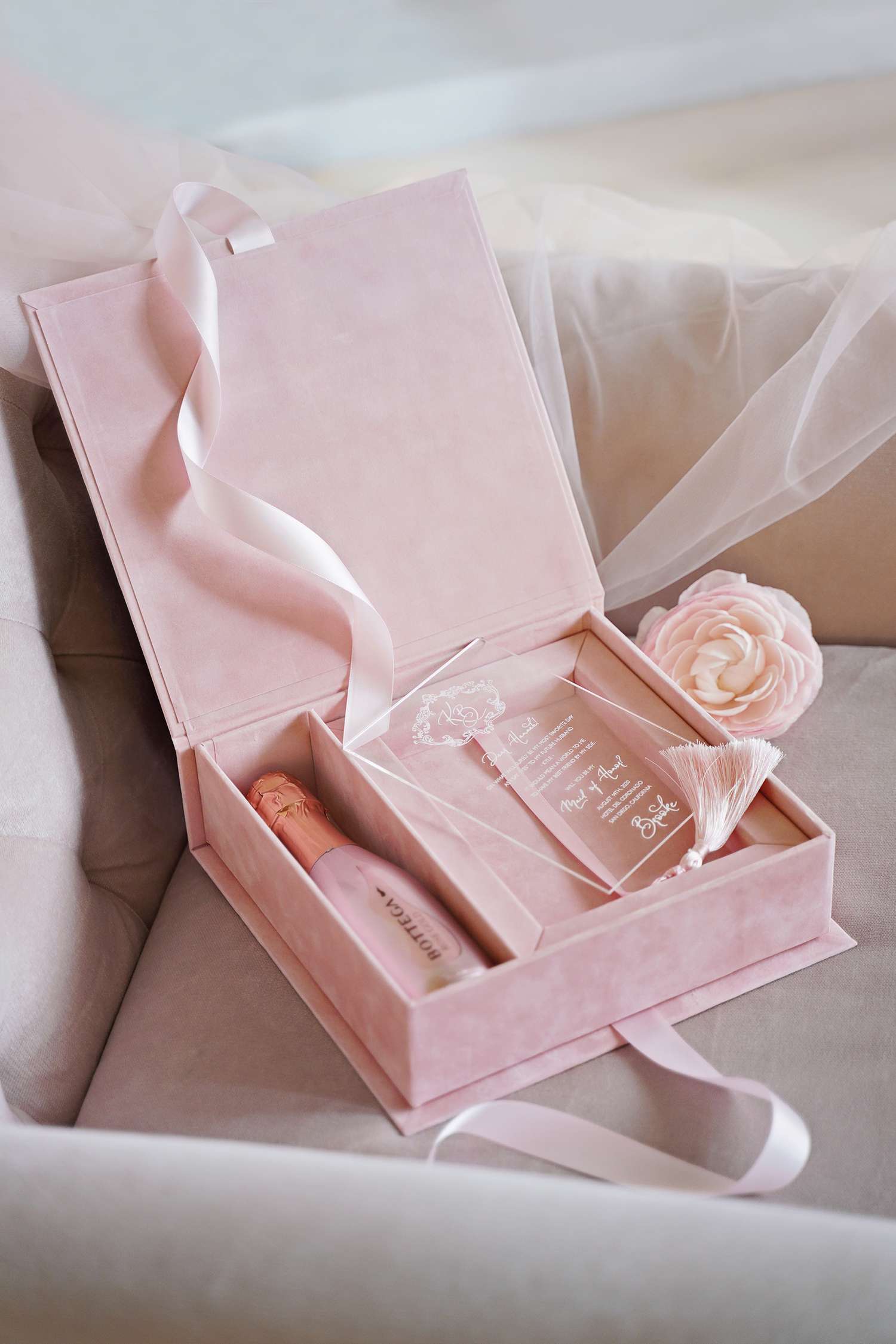  A pastel pink boxed wedding invitation.