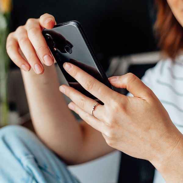 woman texting on black iPhone