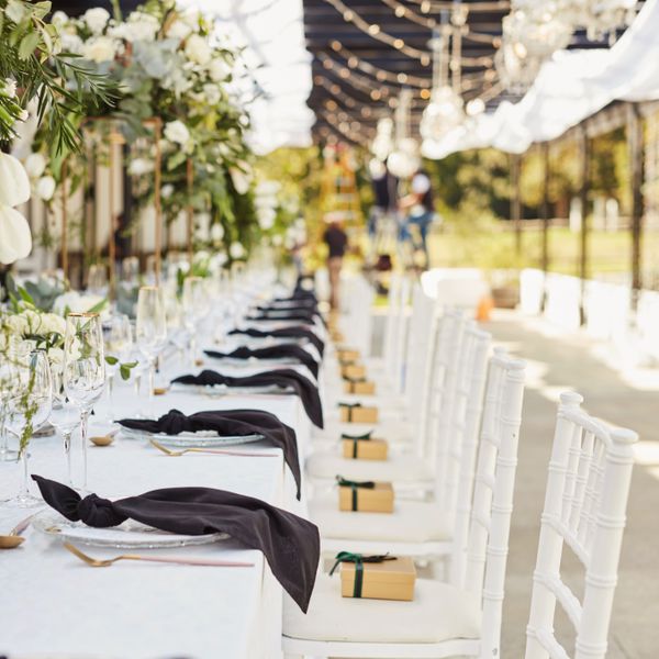 A wedding reception table set with place settings before dinner.