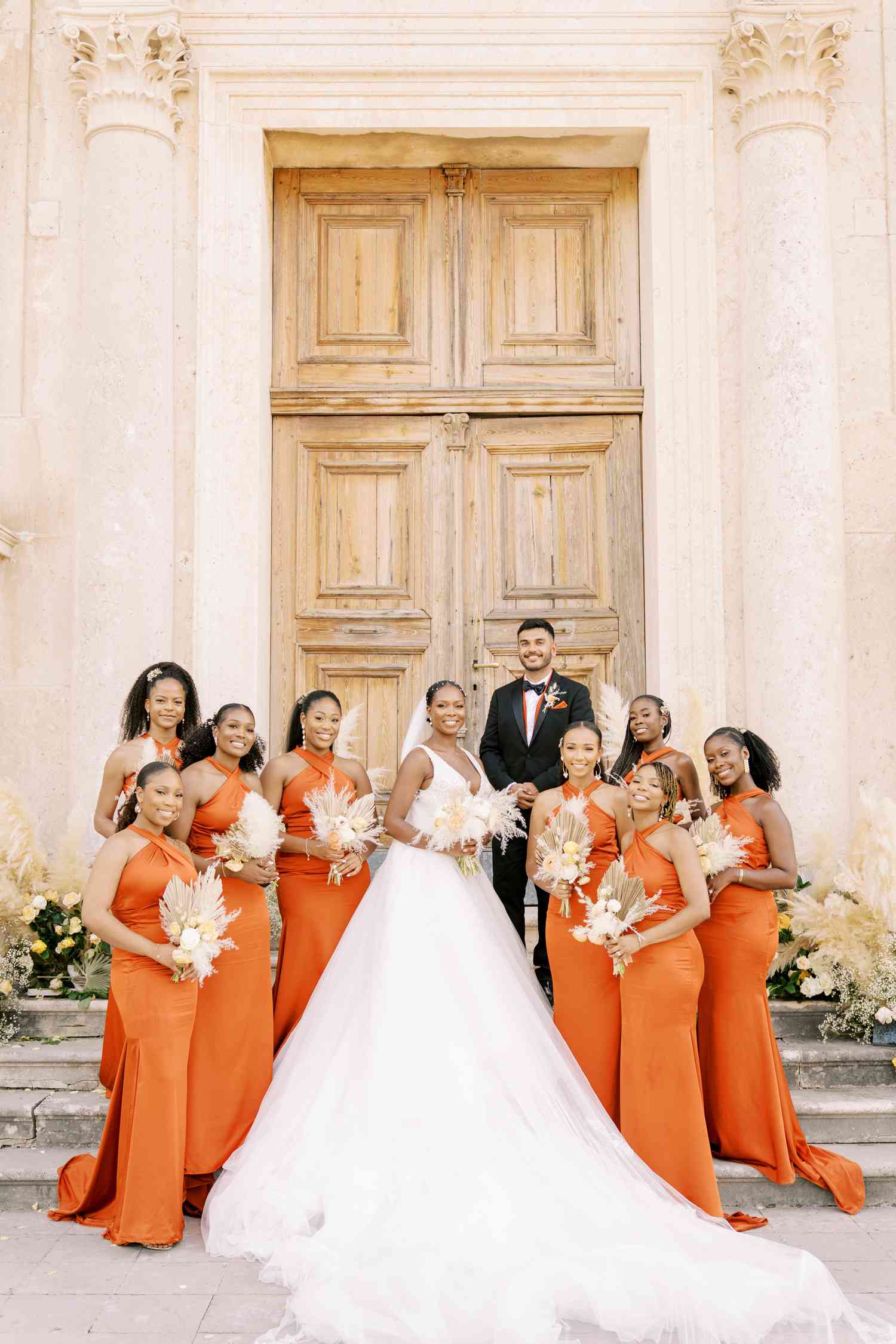 bride and bridesmaids wearing orange dresses