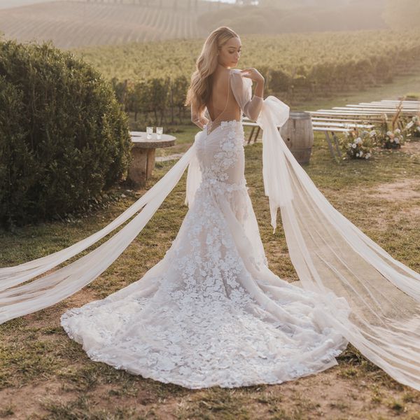 a bride taking a photo in a wine vineyard