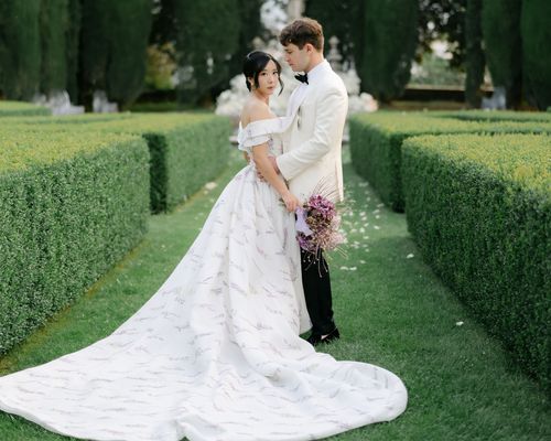 bride and groom posing in a grass maze