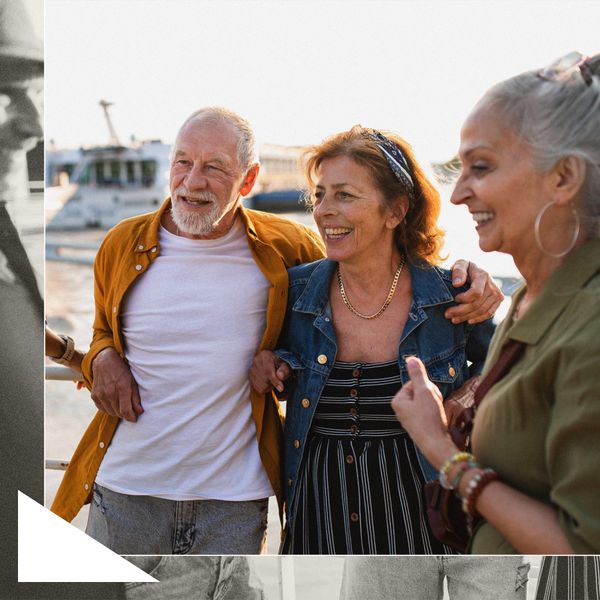 Two Older Women and Man in Summer Clothes Cheerful in Front of Lake 