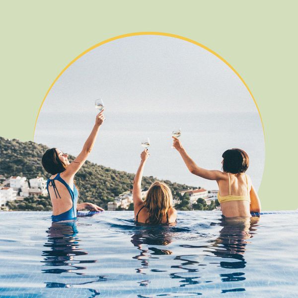 Women Raising Glasses in Pool