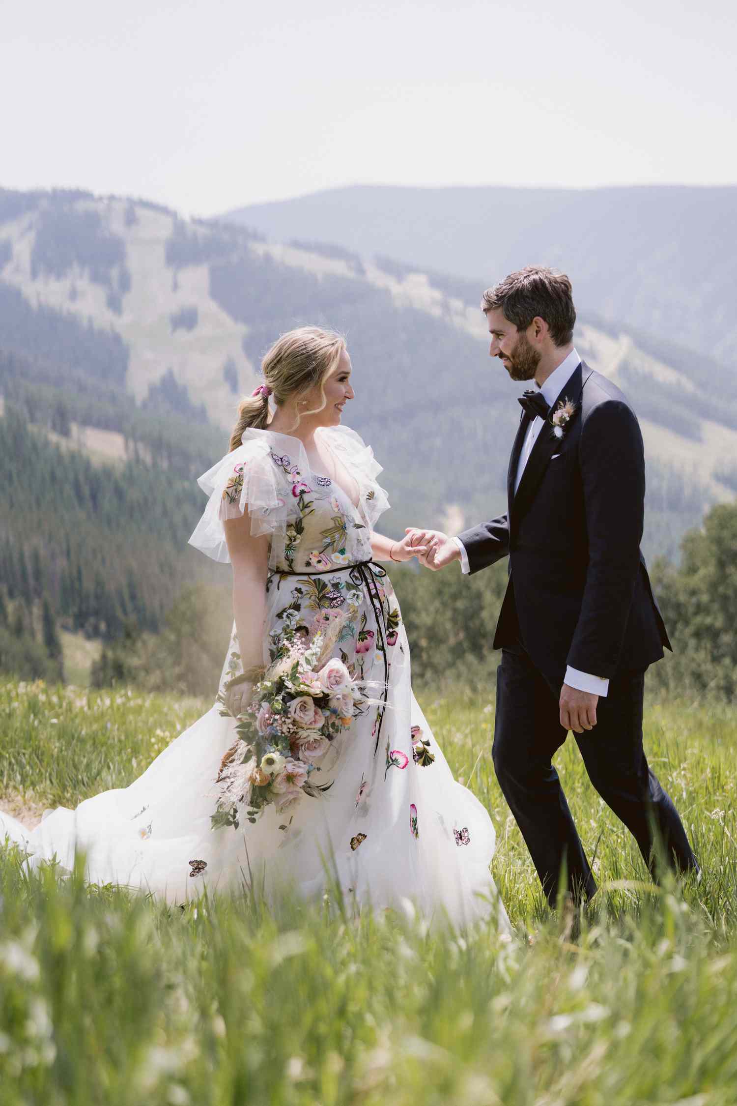 bride and groom portrait set against a mountainous backdrop