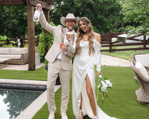 Country Music Star Cole Swindell Posing With His Wife at Their Wedding Reception