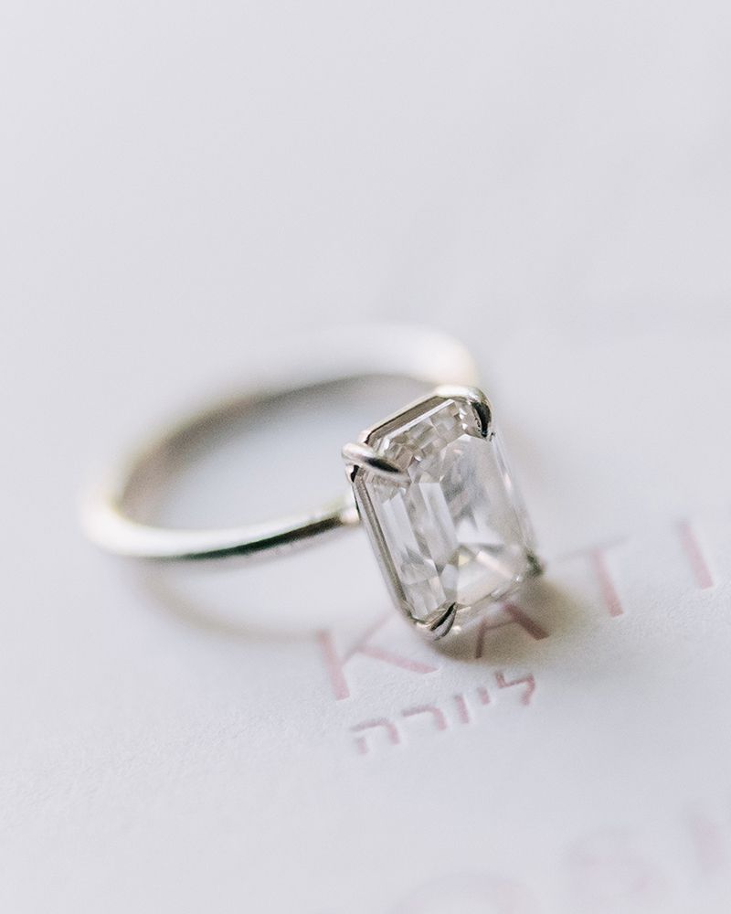 solo shot of an emerald cut diamond engagement ring in a silver setting