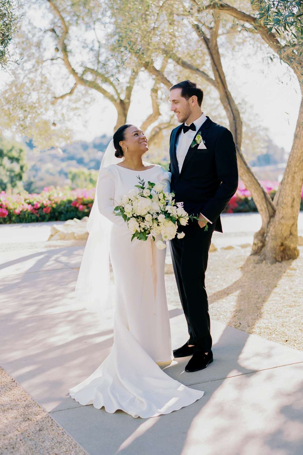 bride and groom posing while gazing into each other's eyes