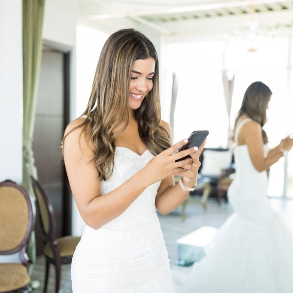 bride In Bridal Attire Holding Smartphone