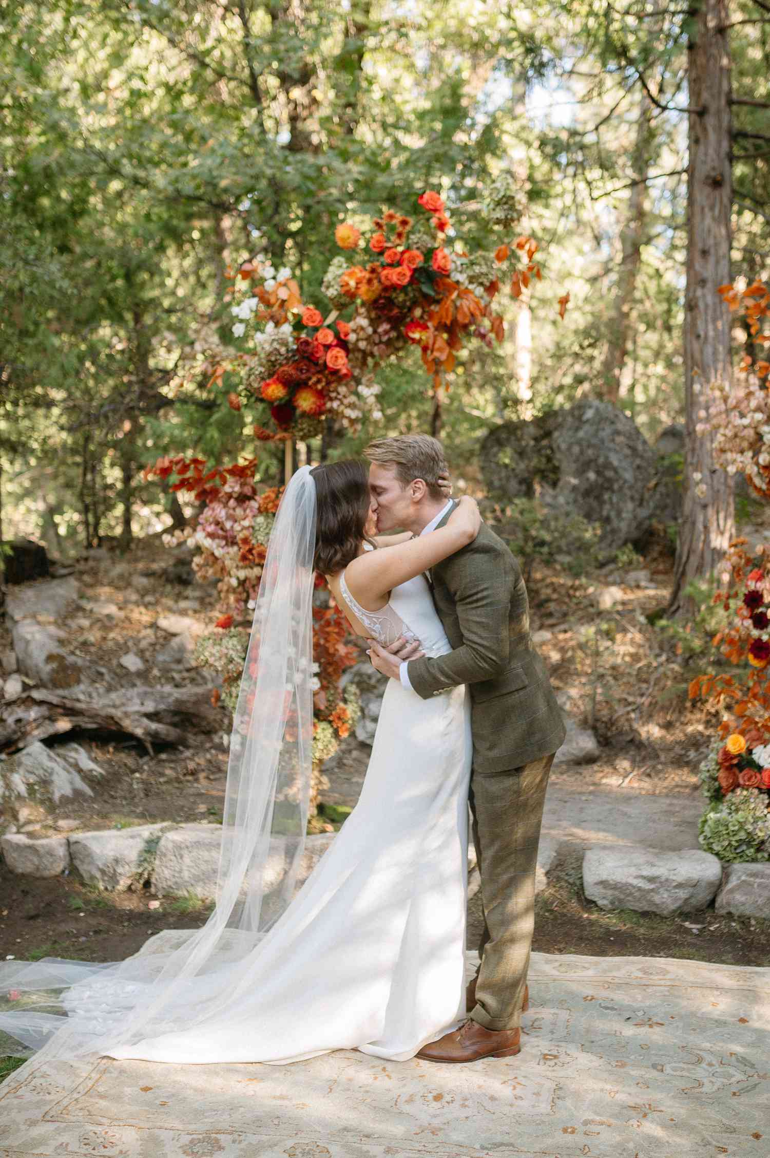 bride and groom kissing at the altar