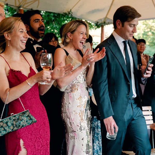 Wedding Guests in Cocktail Attire Clapping in Tented Reception Space