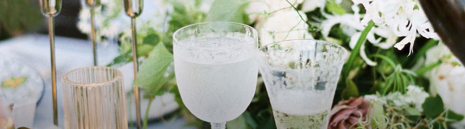 image of a reception table with champagne glass and flowers