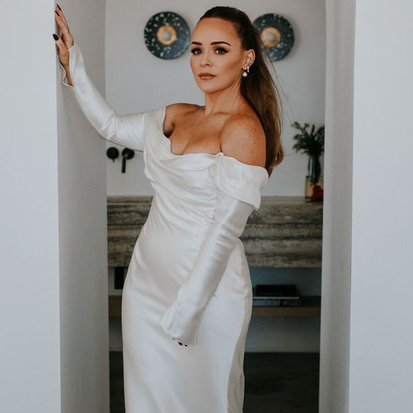 bride posing in her off-the-shoulder wedding gown