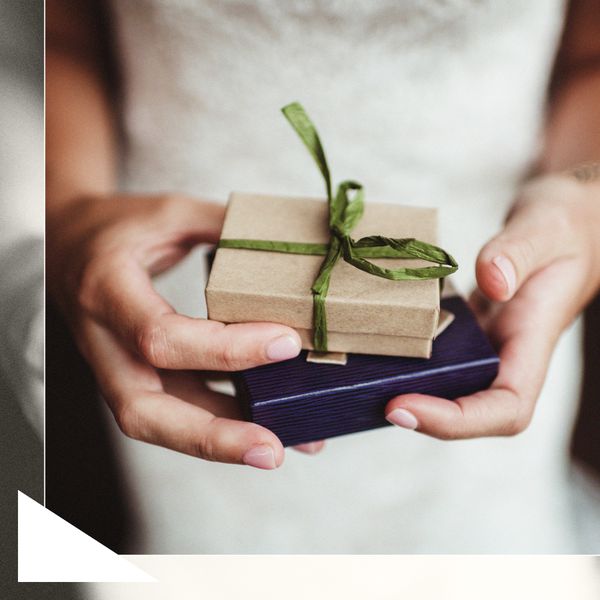 Bride in White Dress Holding Small Gifts