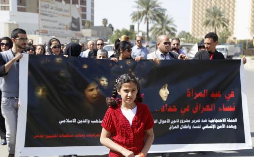 Protesters take part in a demonstration against the draft of the "Al-Jafaari" Personal Status Law during International Women's Day in Baghdad, March 8, 2014. The sign reads, "Women are not for sale or purchase." REUTERS/Thaier al-Sudani