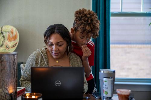 Fulton County Public Schools 5th grader Kareem Williams spends time with his mother, Ebony Williams, a Fulton County Public Schools teacher, during a short break in his online classes during a virtual learning day at their residence in Milton, Georgia, U.S., January 4, 2022, after students have gone remote for a week as cases of the Omicron coronavirus variant continue to surge.