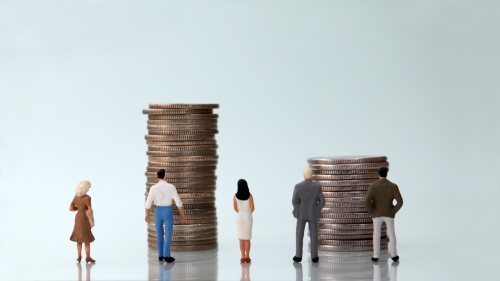 Workers look at money representing wages and inflation