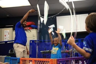 A BCCS student enjoys being insidle a giant bubble during the bubble show.