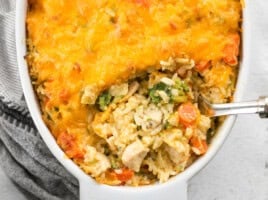 Close up overhead view of a spoon digging into the the chicken and rice casserole.