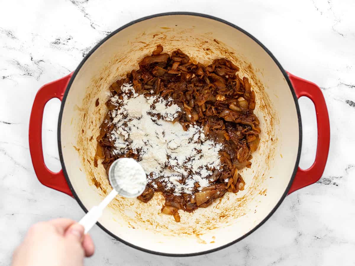 Caramelized onions in the pot, flour being added