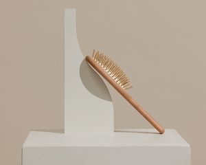 A hairbrush balanced on an abstract fixture