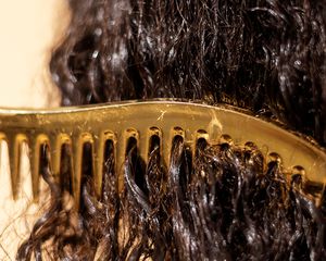 a comb in wet curly dark hair