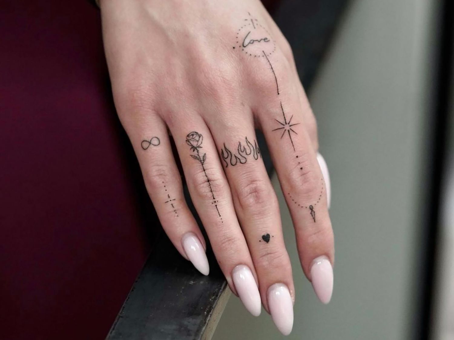 close up of a hand with several small tattoos