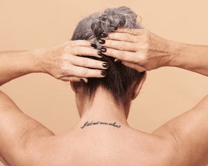 Close up of a woman's back word tattoo.