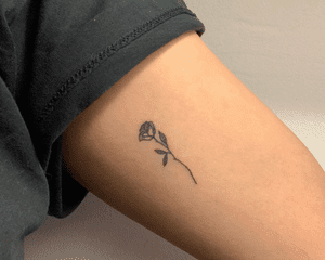 woman with rose tattoo on inside of arm