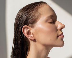 woman with slicked back wet hair