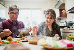 Image of a couple eating at a table