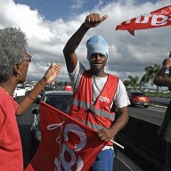 Members of the French union CGT Martinique perform a go slow operation in Fort-de-France, in the French Caribbean island of Martinique, on October 15, 2024, amid riots over rising prices. Authorities in the French Caribbean island of Martinique have extended a night-time curfew following a new wave of riots over spiralling food prices, while talks between authorities and protesters have stalled. In recent weeks the island of 350,000 people has been shaken by violent protests over high food prices.