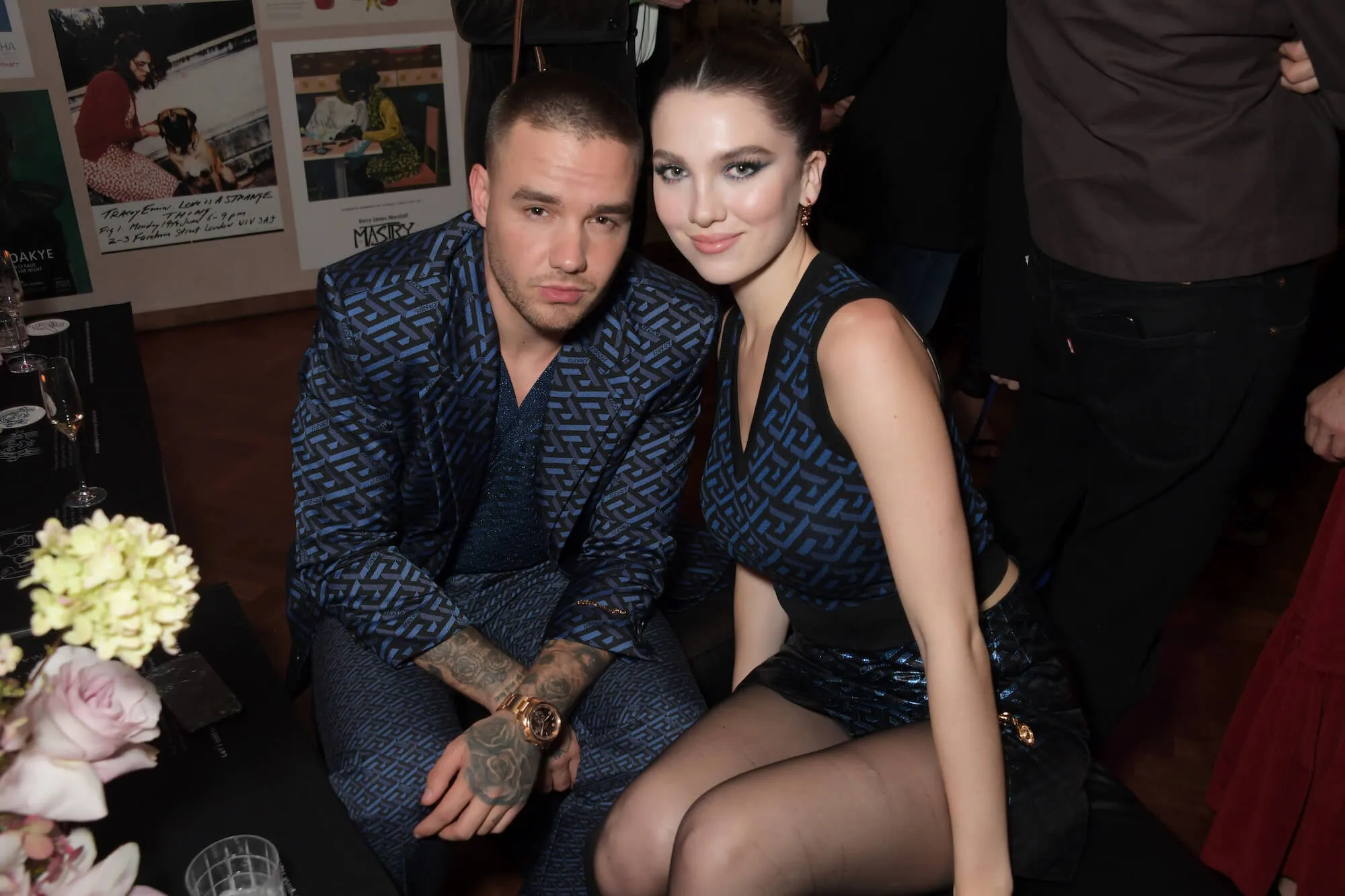 Liam Payne and Maya Henry sitting together with their heads touching