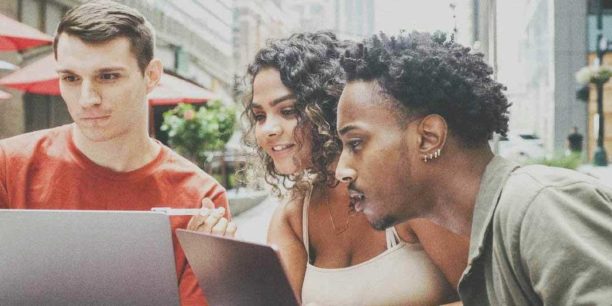 people looking at laptop