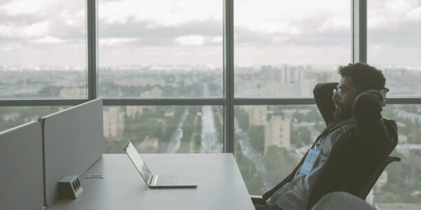 Person sitting at desk working on a laptop