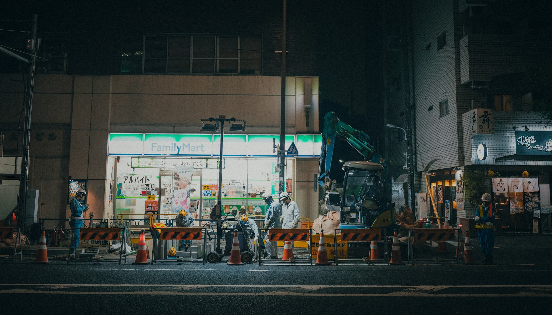 workers on a street at night