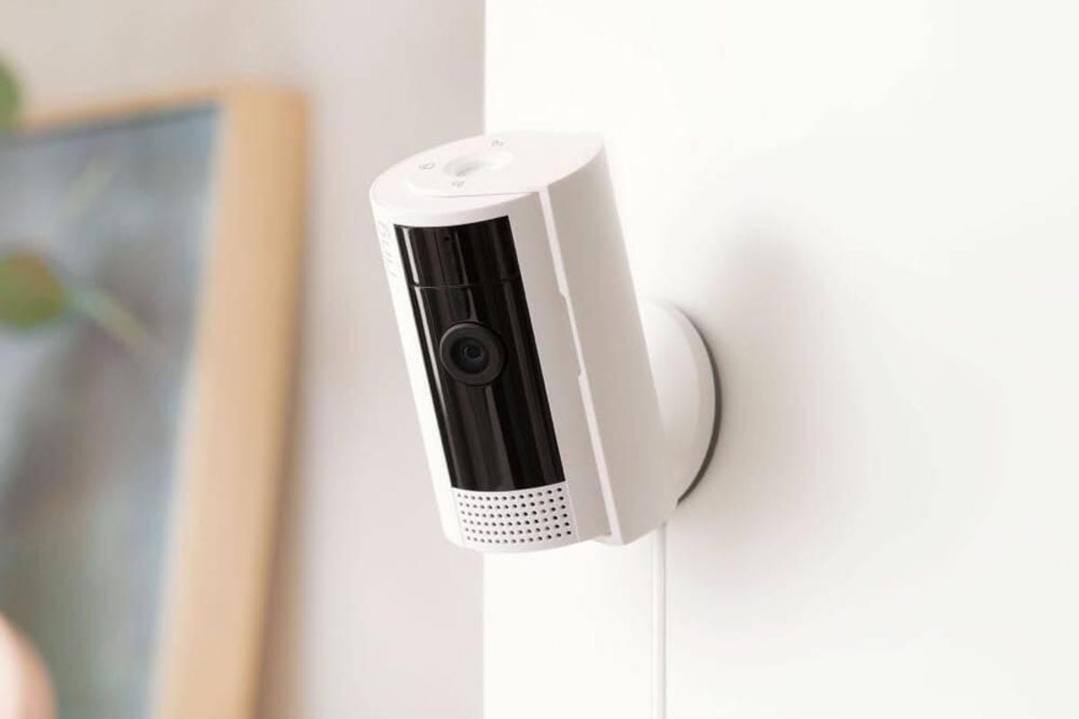 A Ring Indoor Cam mounted on a white indoor wall.