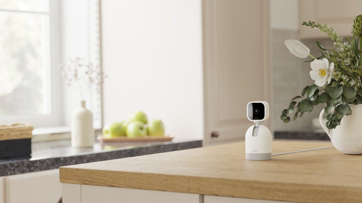 A Blink Mini security camera situated in Blink's new Pan-and-Tilt Mount, which lets the user adjust the direction the camera is facing remotely, from the Blink app.