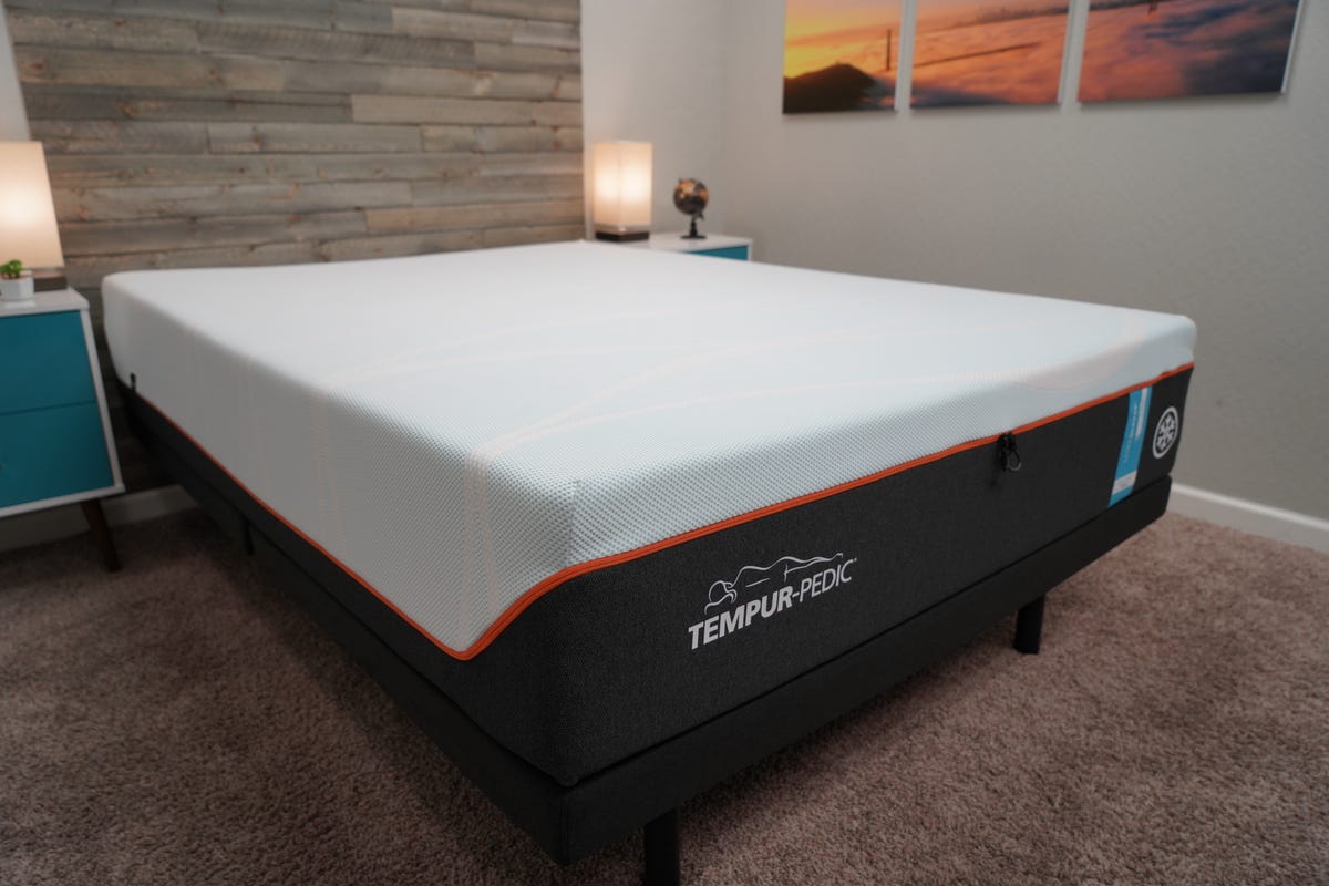 Tempur-Pedic mattress in a bedroom with blue walls.