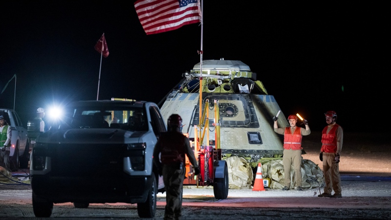 In this photo provided by NASA, Boeing and NASA teams work around NASA's Boeing Crew Flight Test Starliner spacecraft after it landed uncrewed, Friday, Sept. 6, 2024, at White Sands, New Mexico, after undocking from the International Space Station. (Aubrey Gemignani/NASA via AP)