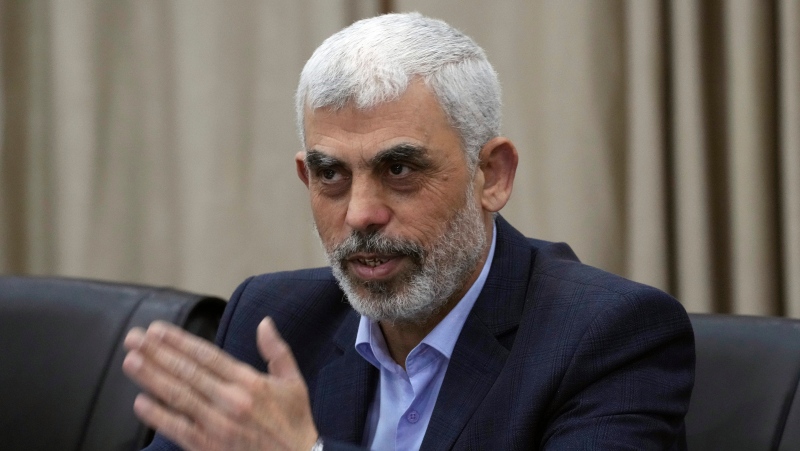 Yehia Sinwar, head of Hamas in Gaza, greets his supporters during a meeting with leaders of Palestinian factions at his office in Gaza City, Wednesday, April 13, 2022. 