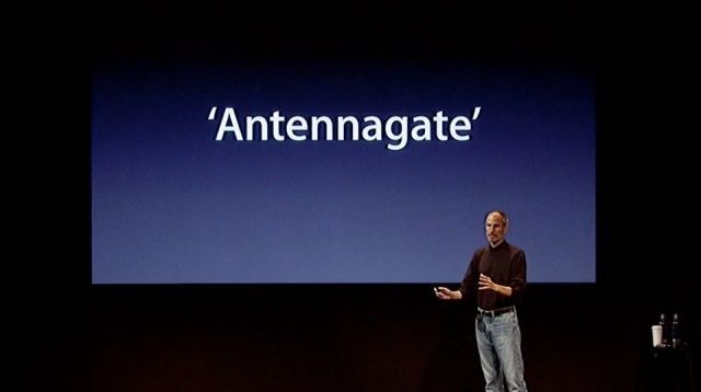 Steve Jobs stands onstage with the word 