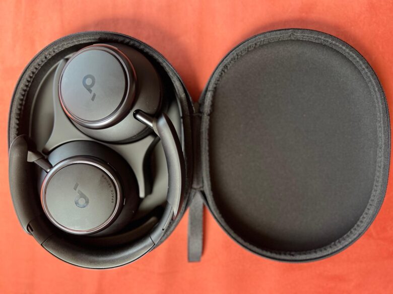 Soundcore Q45 review. The headphones lay flat in their case. They come with an 3.5mm aux cable for wired listening and a USB-A cable for charging.