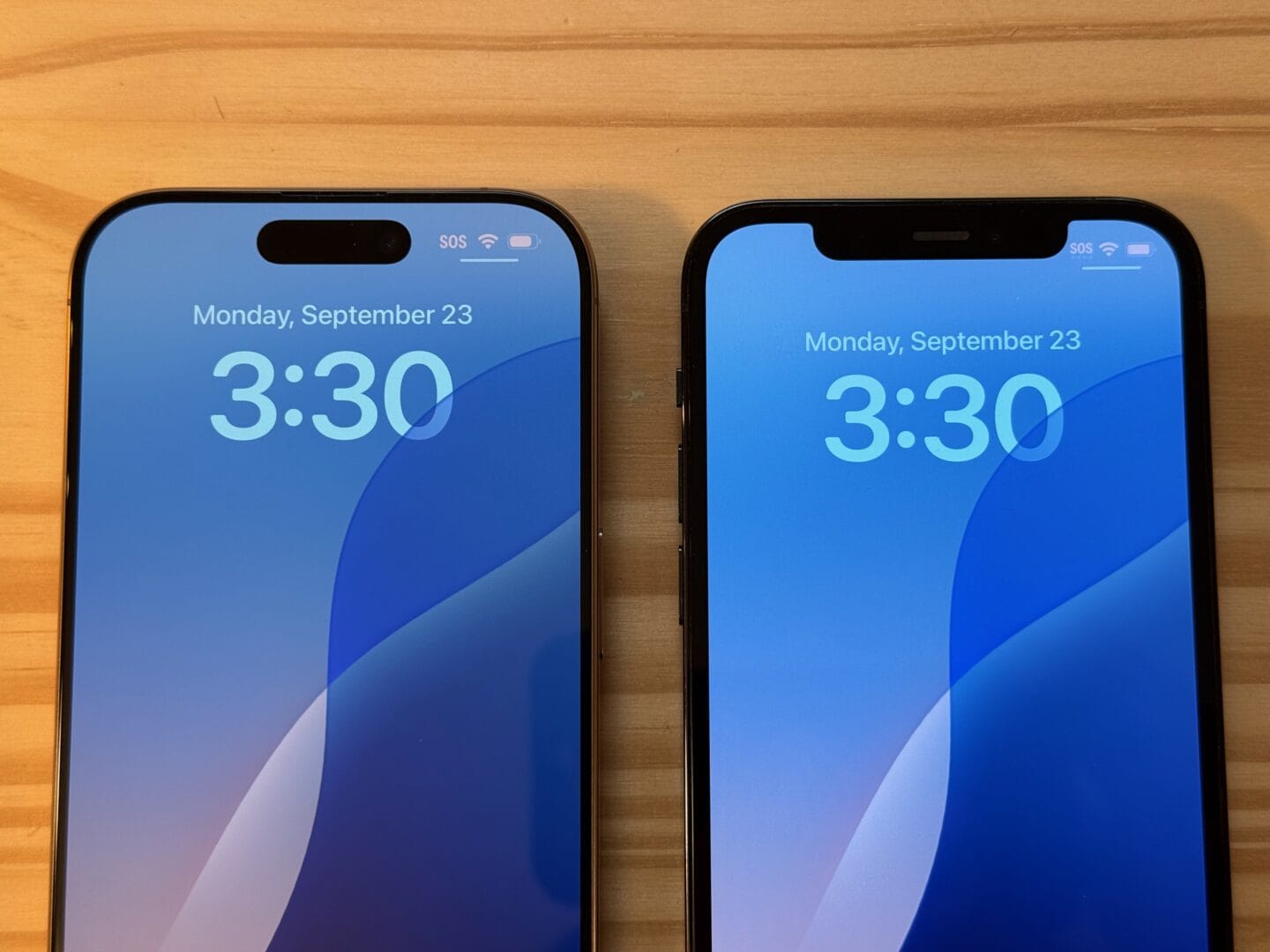 iPhone 12 Pro and 16 Pro face up, showing the thinner bezels and Dynamic Island