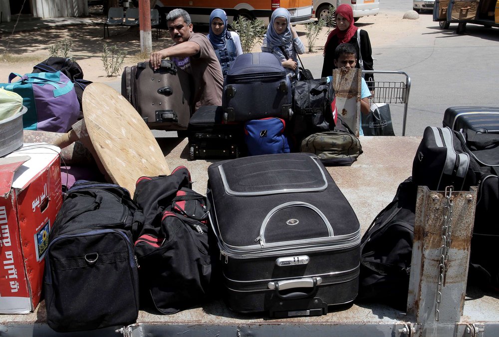 Palestinians load their luggage onto the back of a pick-up truck at the Rafah border on 14 August after Egypt reopened the crossing for limited numbers AFP PHOTO / SAID KHATIB