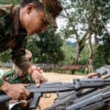 A member of the Ta'ang National Liberation Army in Burma grabs a rifle.