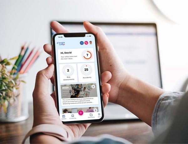 Peninsula Group Limited - Employer checking their health and safety software on their phone