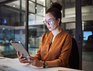 Peninsula Group Limited - Employer using Peninsula's advice line in a dark office late at night