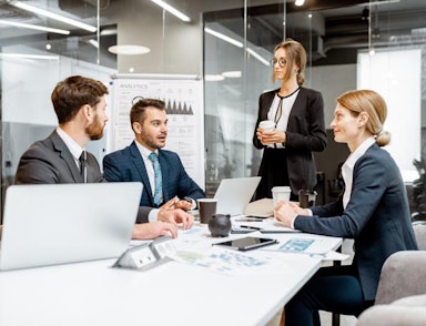 Peninsula Group Limited - A group of legal professionals sat at a desk discussing a legal case